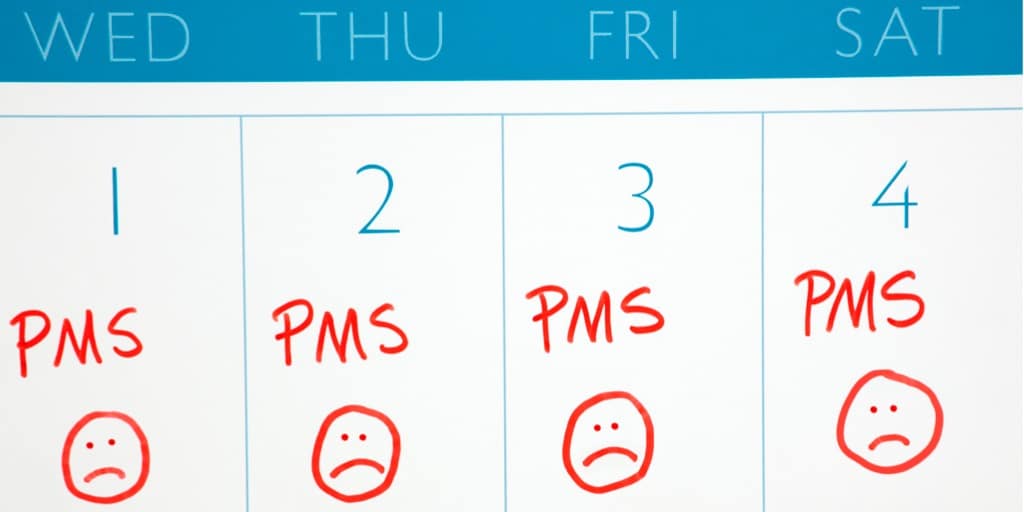 Hvad er PMS? Billede af en PMS-kalender med sure smileys.